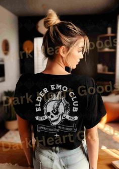 *This shirt has a design on the FRONT & BACK* Step back in time and relive the golden era of emo music with our Elder Emo Music T-Shirt. This comfy tee is the perfect choice for those who still carry the spirit of emo in their hearts. Featuring a captivating design of a beautifully detailed skull and a defiant "rock on" hand gesture, this shirt is a must-have for any elder emo enthusiast. Whether you're searching for an emo gift or wanting to express your undying love for the emo subculture, thi Edgy Short Sleeve Tops With Back Print, Chic Short Sleeve Tops With Back Print For Concert, Black Tops With Custom Print For Concert, Punk Style Pre-shrunk Relaxed Fit Tops, Grunge Style Tops With Custom Print Short Sleeve, Band Merch Tops With Back Print For Concerts, Grunge Custom Print Tops For Fan Merchandise, Grunge Tops With Custom Fan Merchandise Print, Grunge Tops With Custom Print For Fans