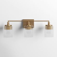 three light brass bathroom fixture with clear glass shades