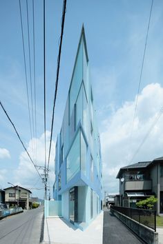 a blue building on the side of a road with power lines in front of it