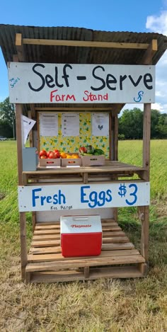 a sign that says self serve farm stand with fresh eggs in the box on it