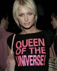 a woman with blonde hair wearing a t - shirt that says queen of the universe