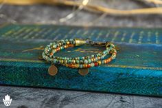 Women's dainty boho chick multistrand bracelet set. This bracelet is made of 3 strands, with a beautiful color mix of green, thanks to the African Turquoise Jasper gemstone, and orange, thanks to the Carnelian gemstone beads.  * little antique bronze coins dangling from the bracelet , elevate the boho vibe. The combination of 4 and  3 mm beads creates a cool texture effect and the golden little spacer beads add a touch of bohemian vibe. The three strands are held together by a cool antiqu bronze Inspiring Bracelets, Layered Bracelets Boho, Green Gemstone Bracelet, Multistrand Bracelet, Handmade Boho Jewelry, Layered Bracelet, Multi Strand Bracelet, African Turquoise, Beaded Wraps