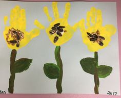 two yellow flowers painted on paper with green leaves and one has a bee in the middle