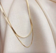 This essential necklace is a must-have for any fashion-forward individual. With its layered design and herringbone pattern, it adds a touch of uniqueness to any outfit. Stand out from the crowd and elevate your style with this one-of-a-kind accessory. Details: Stainless Steel, 18K Gold, waterproof + tarnish resistant, hypoallergenic Gold Collar Necklace, Gold Snake Chain, Double Layer Necklace, Herringbone Chain, Herringbone Necklace, Snake Necklace, Gold Necklace Set, Gold Choker Necklace, Gold Necklace Layered