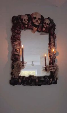 a mirror decorated with skulls and candles