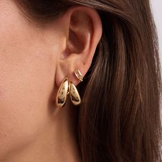 The epitome of understated elegance, these sleek sculptural gold hoops have a two-in-one impact, with an equally lightweight sensibility to them. Chic Gold-tone Hoop Earrings For Formal Occasions, Modern Plated Hoop Earrings, Gold Elegant Hoop Earrings For Everyday Elegance, Elegant Gold Hoop Earrings For Everyday, Chic Yellow Gold Huggie Earrings, Modern Gold-tone Huggie Earrings, Chic Gold-plated Huggie Earrings, Modern Gold-tone Huggie Earrings For Pierced Ears, Contemporary Everyday Gold Jewelry