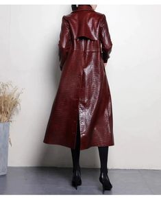 Embrace the timeless allure of sophistication with our Glossy Faux Leather Trench Coat. Tailored to perfection. this coat offers a seamless blend of functionality and high-fashion sensibility. ideal for the woman who commands attention in the boardroom and beyond.Crafted from premium faux leather that replicates the luxurious appeal of the real thing. the coat's surface boasts a lustrous sheen that catches the light and captivates the eye. The innovative PU material provides a cruelty-free alter Fall Evening Single-breasted Outerwear, Elegant Burgundy Outerwear For Party, Elegant Burgundy Party Outerwear, Chic Red Long Outerwear, Burgundy Winter Outerwear For Office, Chic Long Red Outerwear, Luxury Burgundy Outerwear For Winter, Luxury Burgundy Winter Outerwear, Elegant Burgundy Single-breasted Outerwear