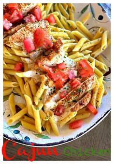 pasta with chicken, tomatoes and sauce on it