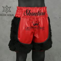 a mannequin wearing red boxing shorts with black fur on the bottom and sides