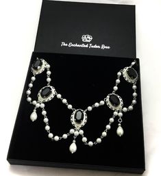 Tudor pearl drop necklace fit for a Queen. The necklace is made with silver plated findings, multi faceted crystals and faux glass pearls. The necklace has an extension chain to the back. It sits beautifully with the decolletage of a Tudor gown. Choose from jet black, emerald green, deep red or gold crystals. The necklace will come in my gift box. We are not able to send international orders to a P.O Box. Please ensure you provide a street address and a telephone number so that we can ship your Medieval Queen, Tudor Gown, Queens Jewels, Gold Crystals, Tudor History, Pearl Drop Necklace, Historical Reenactment, Writing Gifts, Rose Gift