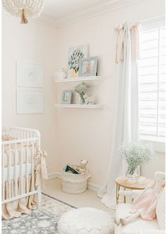 a baby's room with white walls and furniture