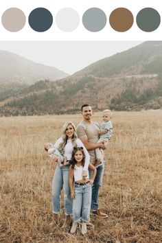 a family standing in the middle of a field with mountains in the background and color swatches