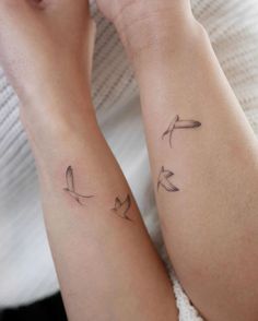 two people with matching tattoos on their arms