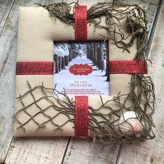 a gift wrapped in burlap and tied with red ribbon