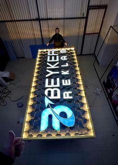 a man standing on top of a large sign