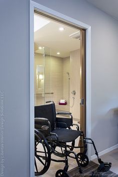 a bathroom with a shower and wheelchair in it