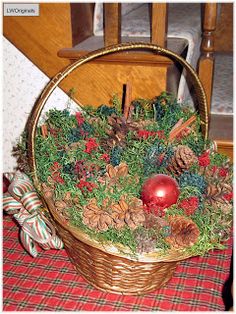 a basket filled with pine cones and christmas decorations