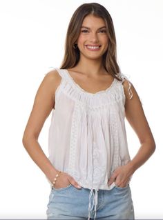 The Cheryl Embroidered Sleeveless Top Natural is a one-of-a-kind piece that will elevate any wardrobe. Made from 100% Indian cotton, this top is not only soft and comfortable, but also environmentally friendly. The natural color adds a touch of simplicity and elegance, making it perfect for any occasion. The intricate embroidery on the top adds a unique and bohemian touch, making it stand out from other tops. The sleeveless design is perfect for warmer weather and can be easily layered for coole Feminine Cotton Embroidered Top For Daywear, Spring Cotton Camisole With Floral Embroidery, Spring Floral Embroidered Cotton Camisole, Embroidered Cotton Camisole Top, Spring Floral Embroidery Cotton Camisole, Sleeveless Cotton Tops With Lace Trim, Cotton Sleeveless Camisole With Floral Embroidery, White Bohemian Cotton Camisole, Summer Sleeveless Embroidered Cotton Top