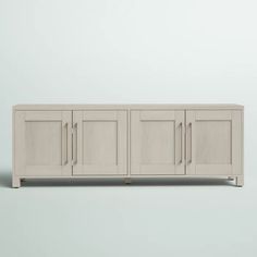 a white cabinet with four doors on the front and two drawers on the back, against a light gray background