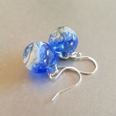 Murano Glass Earrings. Glossy Blue Glass Ball With Airy Bubbles Inside.925 Sterling Silver Hooks. These cute and very elegant earrings are perfect for a special day. Approximate size:  Width 1.5cm Length 1.7 cm Length with hook 3.3 cm You can see the size in the photo! All of the glass is annealed inside a digital kiln  for strength and durability! Each pair of earrings is unique and different from the others! Your pair of earrings will always be exclusive! Great gift for yourself or your friend Blue Glass Earrings For Gift, Blue Round Glass Earrings, Blue Hypoallergenic Party Earrings, Hypoallergenic Blue Earrings For Party, Blue Hypoallergenic Earrings, Hypoallergenic Blue Earrings, Handmade Blue Glass Earrings, Round Blue Glass Jewelry, Blue Hypoallergenic Glass Earrings