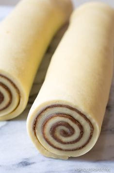 two rolled up food items sitting on top of a counter