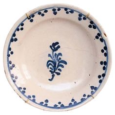 a blue and white bowl with an ornate design on the bottom, sitting in front of a white background