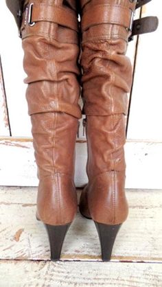 "90s vintage high heel brown leather knee high buckle boots/Aldo boots/belted boots/37 Measurements... - marked size: 37 - insole length: 9.5\" - width at ball: 3\" -heel: 4\" -circumference: 14\" Features... -classic brown hue -genuine leather -ruched detail -working buckle details -interior zipper -Aldo -90s vintage Condition... -excellent vintage condition -minor leather wear -minor wear on heels/soles -white mark on heel has been cleaned off since the photo (photo 1) SH1308" Brown Knee-high Heeled Boots With Buckle Closure, Brown Wide Calf Mid-calf Boots With Buckle Closure, Wide Calf Brown Mid-calf Boots With Buckle, Vintage Brown Knee-high Moto Boots, Vintage Brown Knee-high Boots For Winter, Brown Knee-high Moto Boots Medium Width, Vintage High Heels, Aldo Boots, Classic Brown