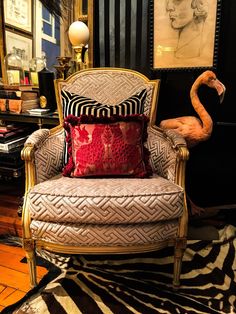 a chair with some pillows and a flamingo