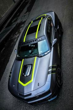 a silver and yellow sports car parked on the street