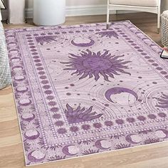 a purple area rug with sun and moon designs on it in the middle of a living room