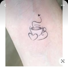 a small tattoo on the ankle of a woman's leg with coffee and hearts