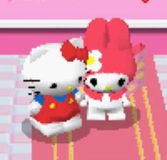 two hello kitty stuffed animals sitting next to each other on a pink background with the words hello kitty