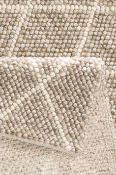 closeup of an area rug with white and beige colors