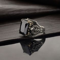 Black Zircon silver gemstone men's ring. We specially designed this ring with unique patterns. We produce this specially designed ring, which can be a memorial gift for your loved ones, with the best quality hand workmanship. DETAILS: - The parts on it are 24 carat gold plated. - The ring is 925 carat silver. WEIGHT: - 17/20g STONE DETAILS: - Stone size / 16x12mm - Black Zircon natural stone/Blue Aquamarine natural stone PRODUCTION METHOD: - Handcrafted with care INTERNATIONAL SHIPPING: - We use Black Signet Ring, Luxury Gothic Men's Sterling Silver Ring, Luxury Silver Onyx Men's Ring, Hand-cast Black Skull Ring In Sterling Silver, Zircon Ring, Ring Black, Aquamarine Blue, Silver Rings Handmade, Elegant Jewelry