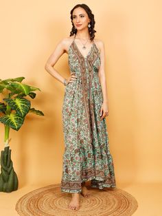 Summer Boho Backless  Floral Ethnic  Printed  Dress. Adjusts to Your Size Thanks to the Strings in the Neck and in the Lower Back. The Strings That Tie In The Neck And In The Back Are Elegantly Decorated With Beads And Handmade Pompoms. This Elegant Flowing Dress is Light and Does Not Wrinkle, It is Made of Polyester. Its Touch is Soft Like Silk But It Is Much Easier to Care. Fluid, Light and Comfortable Fabric with Colorful Prints, Making It  The Ideal Summer Dress For The Beach, a Party or Whe Bohemian Flowy Halter Dress With V-neck, Green Bohemian V-neck Beach Dress, Bohemian V-neck Halter Dress For Vacation, Boho Print V-neck Beach Dress, Ethnic Print Dress, Festival Boho Print V-neck Beach Dress, Green Halter Dress, Long Halter Dress, Flowing Dresses