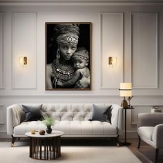 a living room filled with furniture and a painting hanging on the wall over a white couch