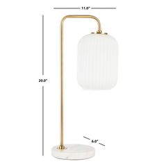 the brass and white lamp is shown with measurements