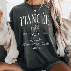 ORDER BY DECEMBER 10TH TO ENSURE CHRISTMAS DELIVERY.  ORDERS WILL STILL BE ACCEPTED AFTER THIS DATE, AND WILL BE PROCESSED AS SOON AS POSSIBLE, BUT MAY NOT ARRIVE BEFORE CHRISTMAS DAY.  PLEASE PLAN ACCORDINGLY AS REFUNDS WILL NOT BE PROVIDED FOR ORDERS THAT ARE DELIVERED WITHIN THIER ESTIMATED WINDOW.   Did you recently get engaged?  This custom FUTURE MRS FIANCÉE Comfort Colors® t-shirt is the perfect way to show your excitement for your newly engaged status.  The addition of your future last n Future Mrs Gifts, Crew Neck Cotton Top For Anniversary, Cotton Crew Neck Top For Anniversary, Engagement Shirts, Newly Engaged Gift, Future Mrs Shirt, Engagement Gifts Newly Engaged, Beach Proposal, Get Engaged