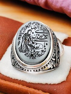 Natural Hematite Islamic Carving Natural Genuine Hadid Imam Riza,Ali bin Musa el-Rıza, Imam & Deer, 925 silver Ring Stone size is 15x20mm Back of ring is open to touch the stone Islamic Scraping,Islamic Men's Ring,Islamic Carving,Islamic Gift for Men,Islamic Unique Gift,Islamic Ring Gift,Silver Men's Ring Handmade Silver Ring,Father's Day Gift,Best Gift for Man,Gift for Muslim Men,Gifts for Boyfriend,Gifts for Dad,Gifts for Girlfriend,Gifts for Husband,Gifts for Mom,Gifts for Sister,Gifts for Wi Silver Carved Signet Ring Gift, Traditional Silver Signet Ring Stamped 925, Artisan Silver Rings With Carved Details, Artisan Carved Silver Rings, Artisan Engraved Silver Ring, Artisan Engraved Silver Ring Collectible, Traditional Silver Signet Ring For Anniversary, Silver Carved Sterling Silver Signet Ring, Silver Antique Carved Rings