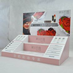 a display case with lipstick and flowers on it