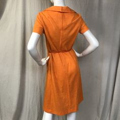 "This is a lovely short sleeve dress in a bright cheery tangerine. There's a zipper (19\") down the back with hooks at the top for the collar. The sleeves are short. There are two pockets at the waist. The belt is included. Details Size: unmarked, fits a modern 4 - 6 Bust: 36\" Sleeve length: 7\" Shoulder: 14.5\" Waist: 32\" Hips: 36\" Length: 41\" Belt: 26\" - 31\" Label: unmarked Colors: Tangerine Condition: Excellent, no issues." Fitted Collared Short Sleeve Spring Dress, Fitted Collared Short Sleeve Dress For Spring, Mod Mini Dress With Short Sleeves, Fitted Orange Cotton Dress, Vintage Orange A-line Dress, Lined Orange Knee-length Dress, Orange Lined Knee-length Dress, Orange Knee-length Lined Dress, Fitted Vintage Orange Mini Dress