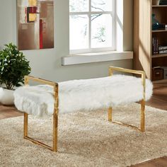 a white bench sitting on top of a rug in a living room next to a window