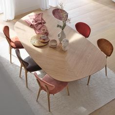 a wooden table with four chairs around it