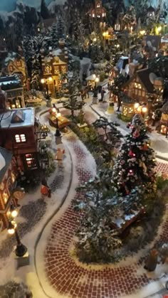 a christmas village with lit up trees and buildings