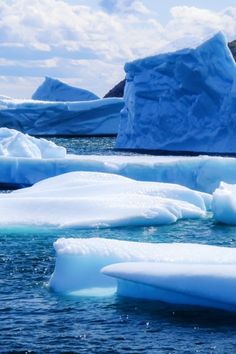 several icebergs floating in the water near each other