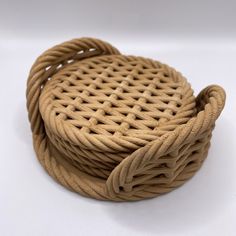 a brown basket sitting on top of a white table