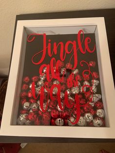 a white frame with some red and silver buttons in it that says, single we are one