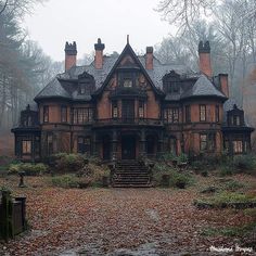 an old house in the woods with lots of leaves on the ground and stairs leading up to it