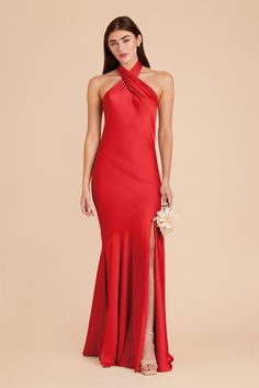 a woman wearing a red dress with an open back and high slits on the side