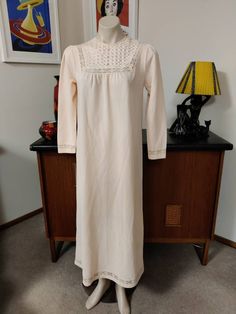 This nightgown would be ideal for a lady looking for a nightgown with sleeves, warmer fabric, higher neckline and a bit more demure and this would fit the bill. The gown has a high neck with a pretty feature on the yoke, a single button at the back to close, long sleeves and long length. Measurements are Shoulder to shoulder 38cm Bust 98cm Sleeves shoulder to cuff 56cm Length shoulder to hem 31cm Beige Long Sleeve Maxi Dress With Lace Trim, Fitted Long Sleeve Vintage Nightgown, Long Sleeve Dresses With Lace Trim For Night, Long Sleeve Lace Trim Dress For Night, Vintage Fitted Long Sleeve Nightgown, Cream Long Maxi Dress For Daywear, Vintage Long Sleeve Sleepwear For Sleepover, Long Sleeve Nightgown With Lace Trim For Sleepover, Fitted Long Sleeve Nightgown For Sleep